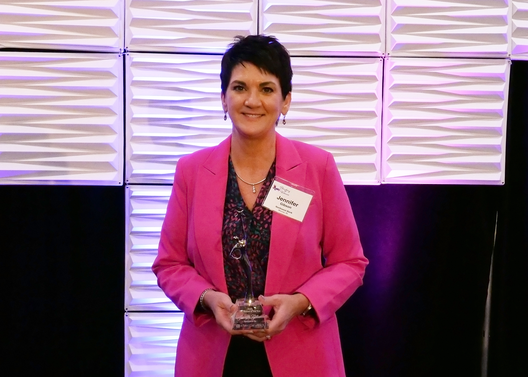 photo showing Jennifer Gibson posing with the 2023 IBA Woman of the Year award